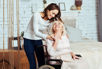 elderly woman smiling to her caregiver